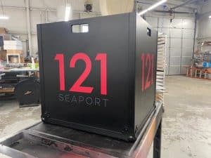 Sizeable black bin with address in red