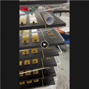 Multiple directory signs in dark wood and gold