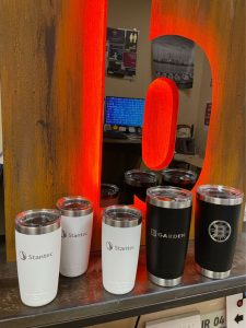 White and Black branded Yeti mugs